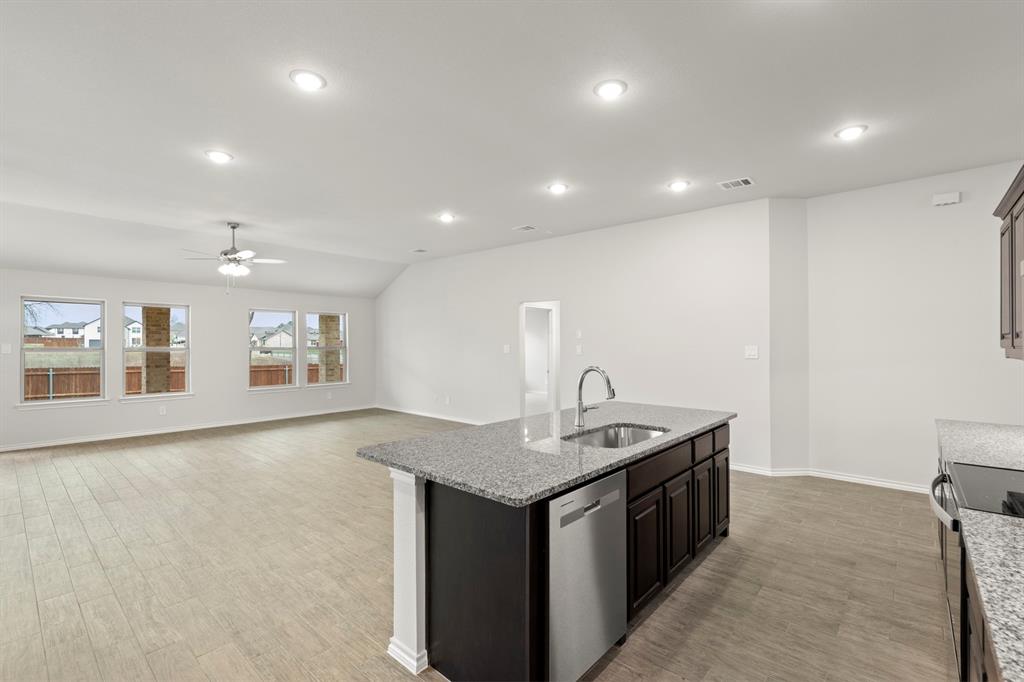 1120 Rushing Court Aubrey, TX 76227 - Photo 7 of 27 a kitchen that has a sink a stove and a table