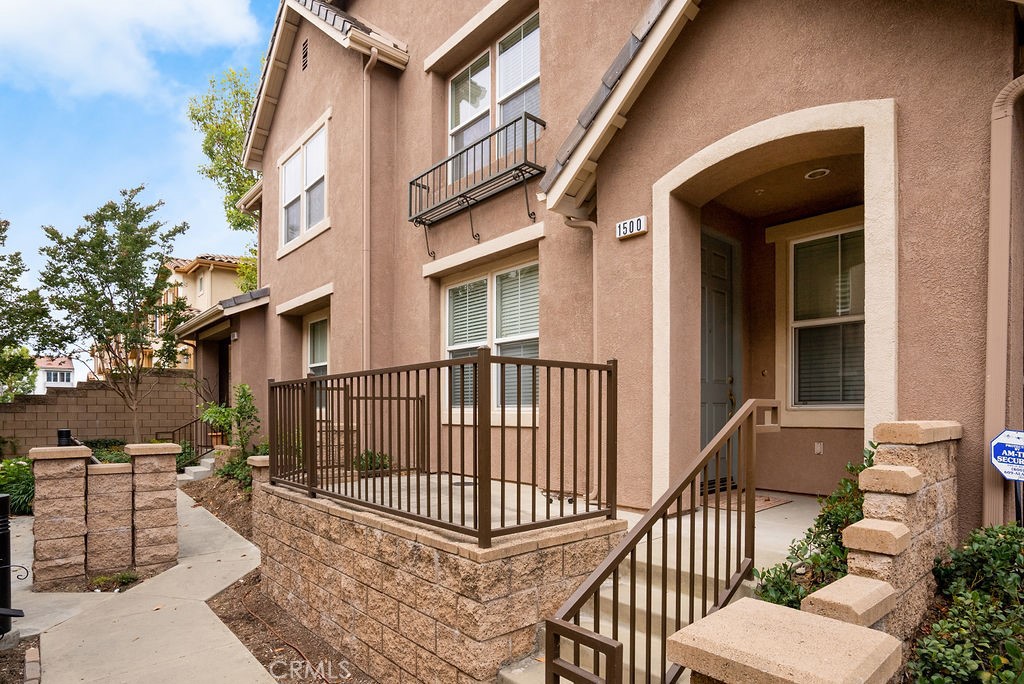 a view of a brick house with many windows