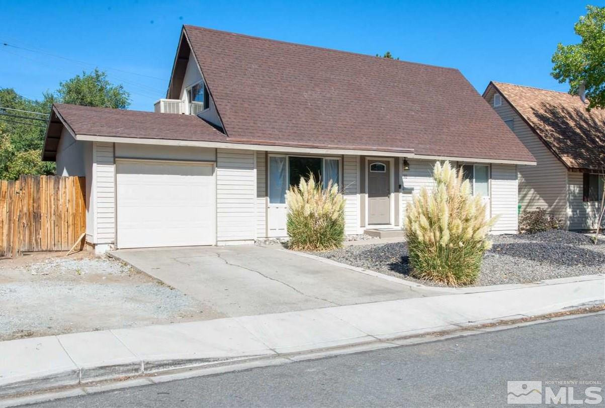 32 Gault Way Sparks, NV 89431 - Photo 1 of 26 a front view of a house with a garden and plants