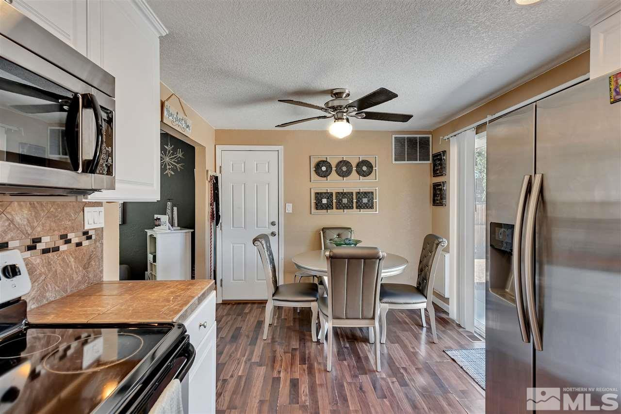 32 Gault Way Sparks, NV 89431 - Photo 12 of 26 a view of a dining room with furniture a chandelier and wooden floor