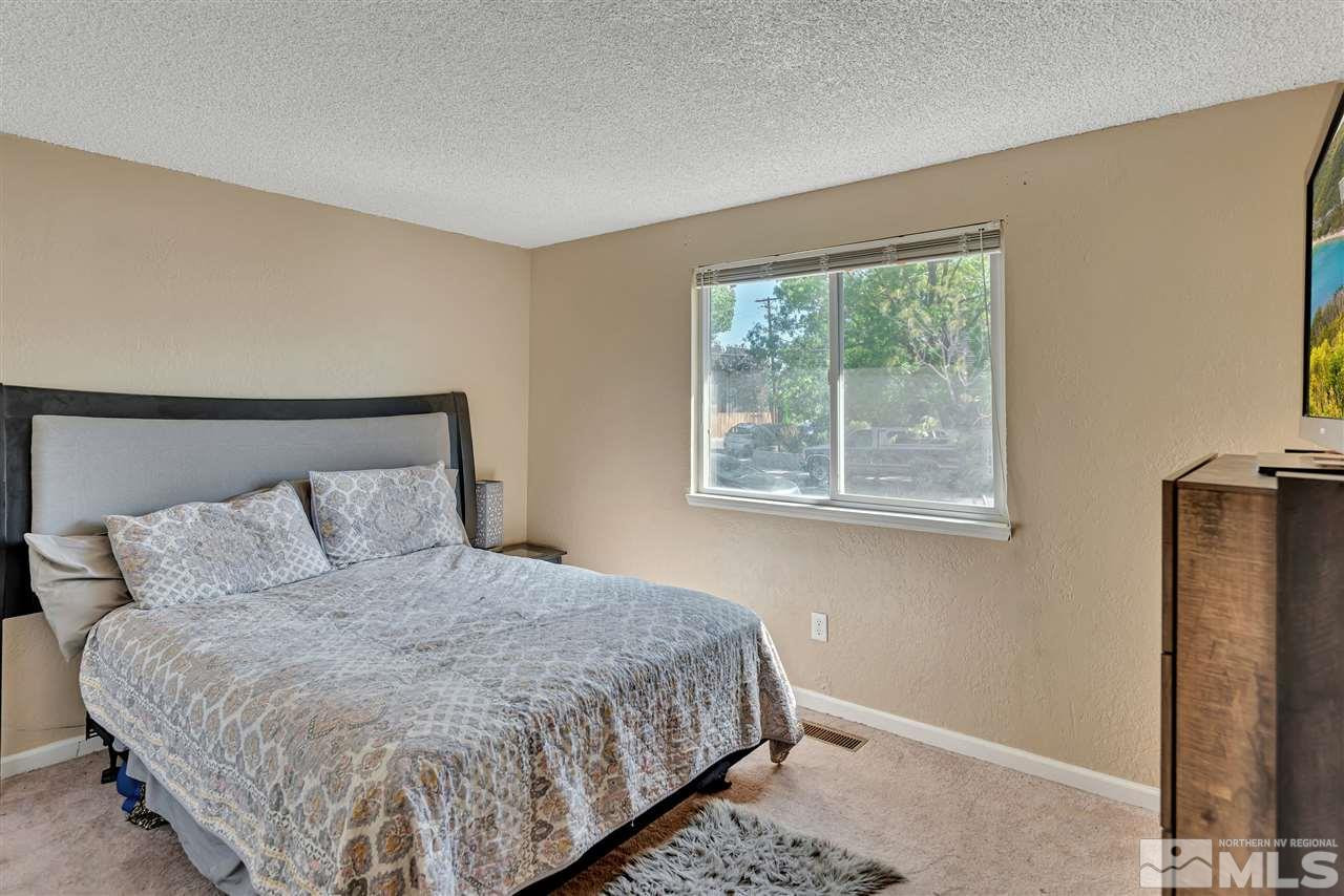 32 Gault Way Sparks, NV 89431 - Photo 13 of 26 a bedroom with a bed and a flat tv screen on the dresser