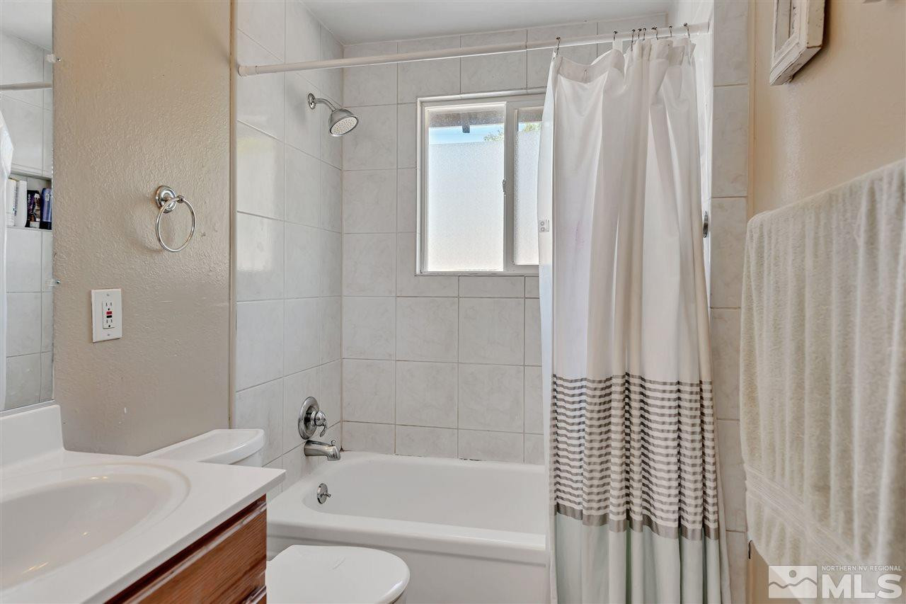 32 Gault Way Sparks, NV 89431 - Photo 16 of 26 a bathroom with a sink a toilet and shower