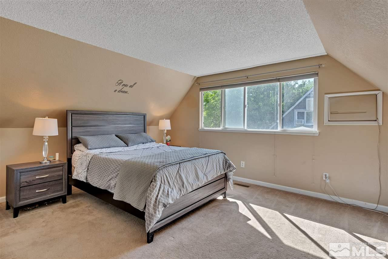32 Gault Way Sparks, NV 89431 - Photo 22 of 26 a bedroom with a bed lamp and window