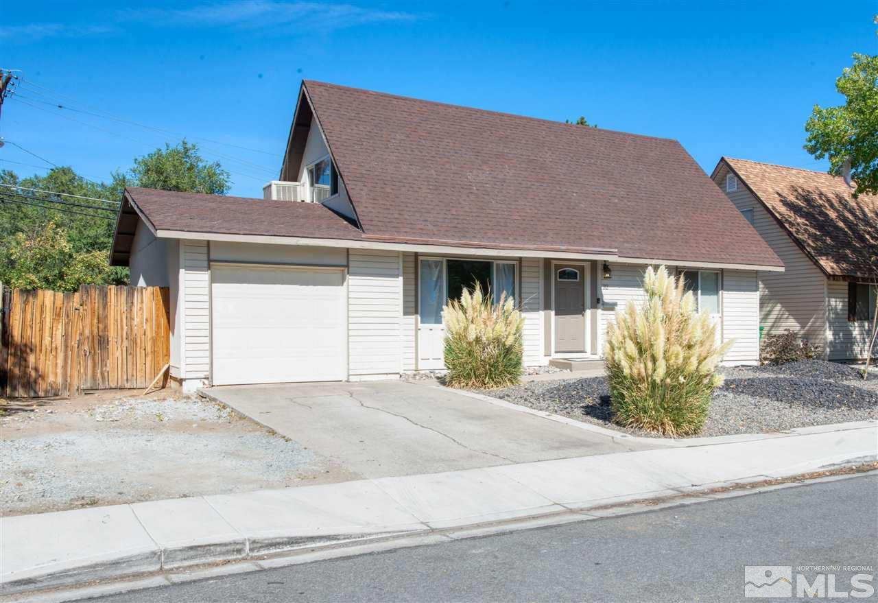 32 Gault Way Sparks, NV 89431 - Photo 24 of 26 a front view of a house with a garden and mountain view