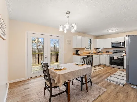 a kitchen with a sink a refrigerator and cabinets