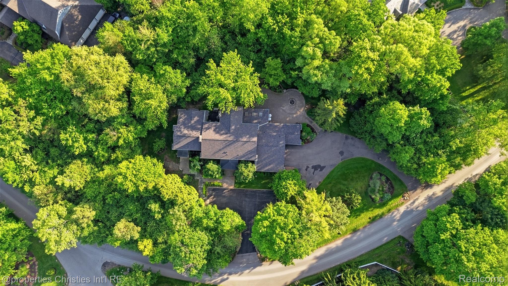 25235 Canterbury Road Franklin, MI 48025 - Photo 49 of 56 Property featuring a multi-gabled roofline, surrounded by abundant mature trees