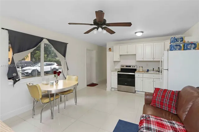 a living room with furniture and kitchen view