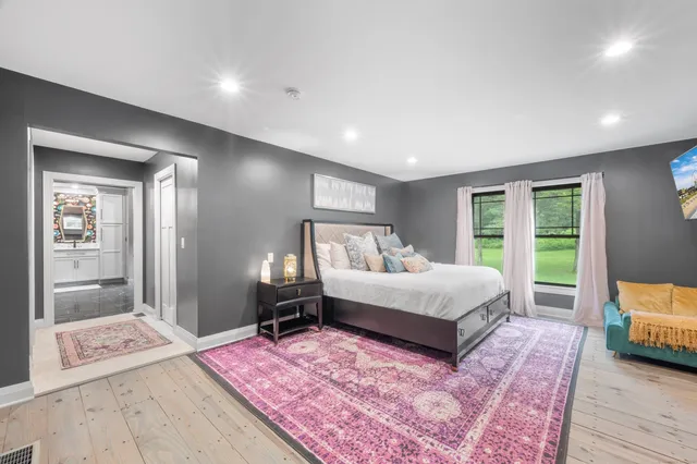 a spacious bedroom with a bed and a couch