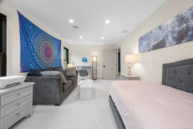 a spacious bedroom with a bed and furniture