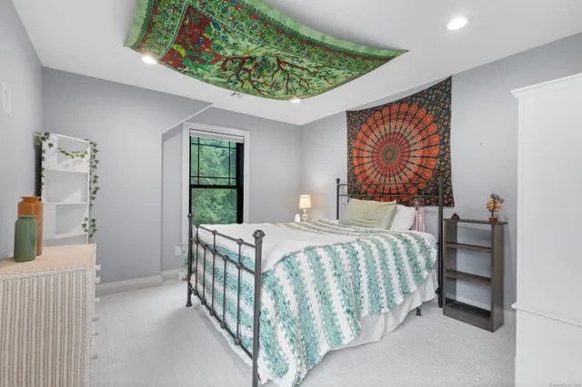 a bedroom with a bed and a window