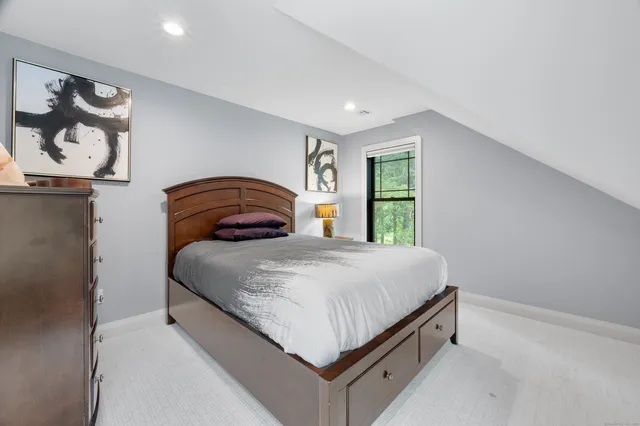 a bedroom with a bed and dresser