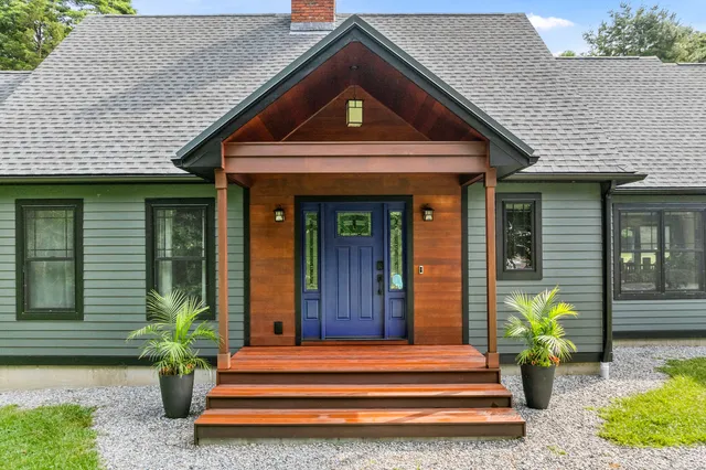 a front view of a house with potted plants