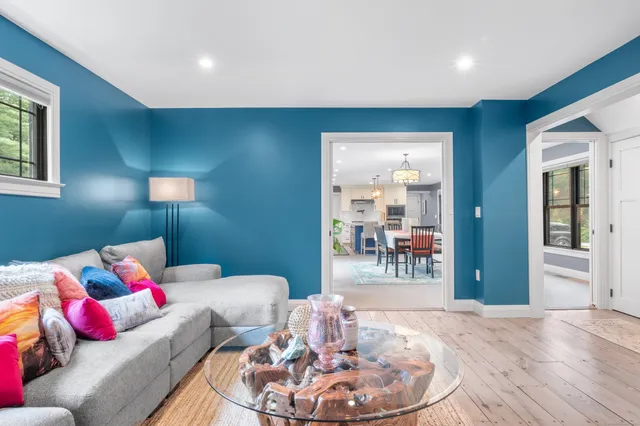 a living room with furniture and a wooden floor