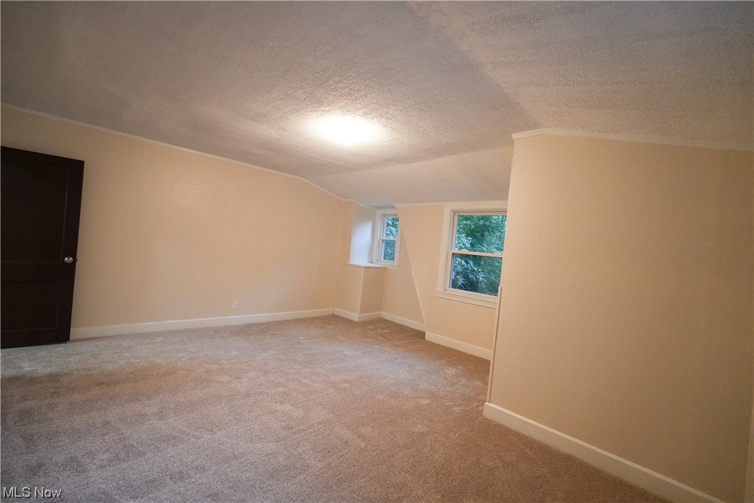 664 Ecton Road Akron, OH 44303 - Photo 23 of 35 Spare room featuring a textured ceiling, and light carpet