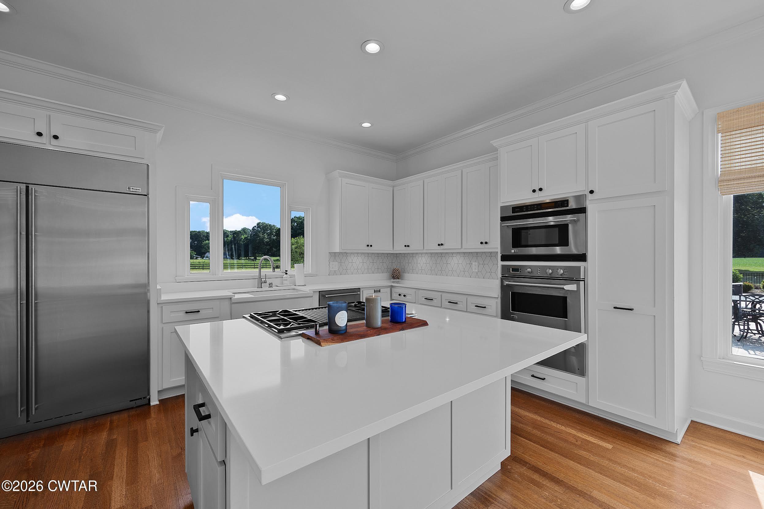 58 Huntington Place Jackson, TN 38305 - Photo 13 of 38 a kitchen with stainless steel appliances a sink a stove a refrigerator and cabinets
