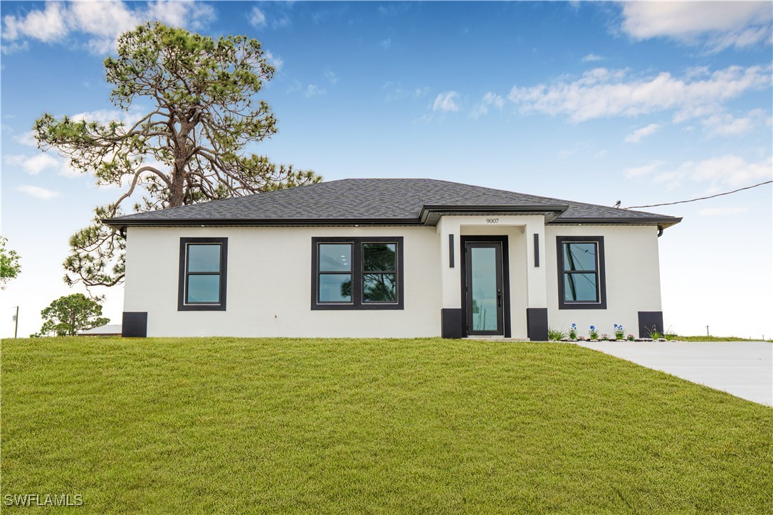 a front view of a house with a garden