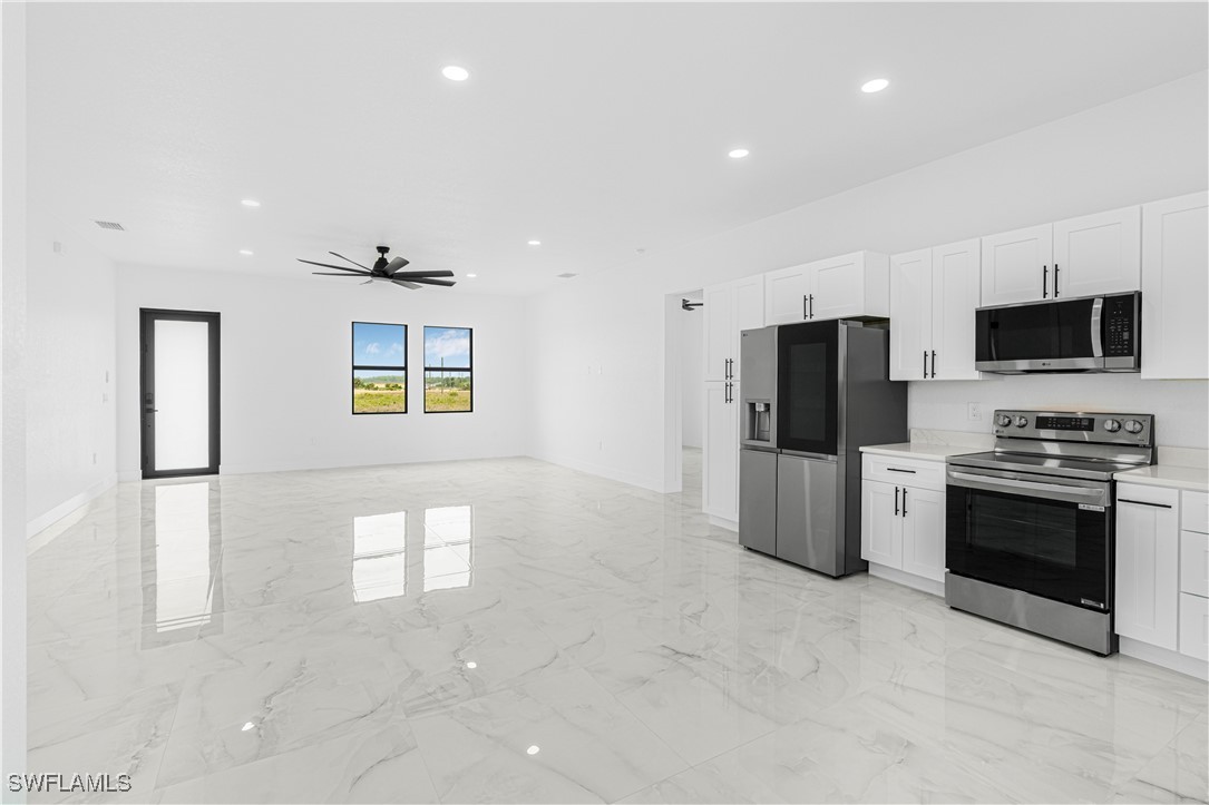 9007 East Crow Circle LaBelle, FL 33935 - Photo 14 of 46 a kitchen with stainless steel appliances a refrigerator stove and microwave