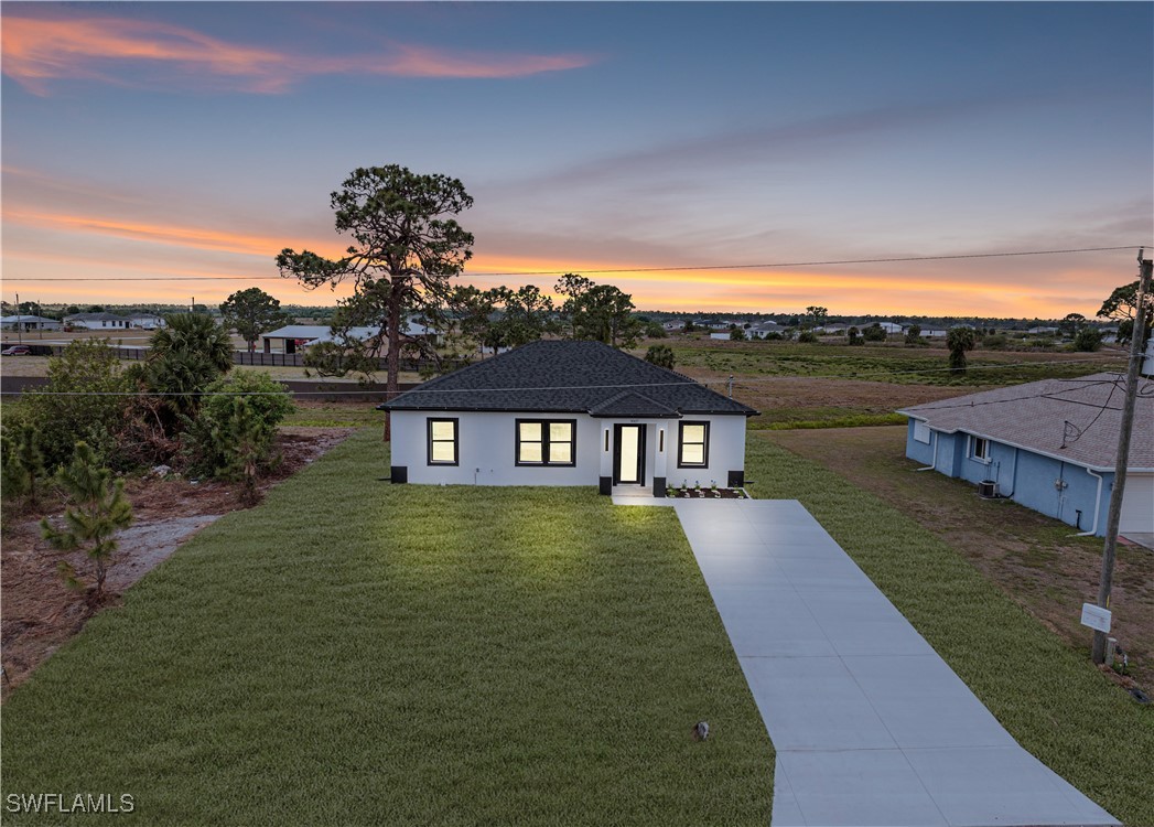 9007 East Crow Circle LaBelle, FL 33935 - Photo 2 of 46 a front view of a house with a yard
