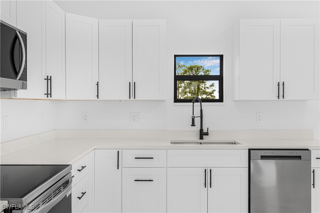 9007 East Crow Circle LaBelle, FL 33935 - Photo 23 of 46 a kitchen with a sink cabinets and a window