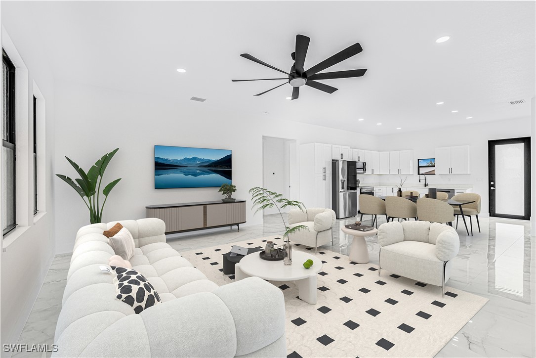 9007 East Crow Circle LaBelle, FL 33935 - Photo 3 of 46 a living room with furniture and a flat screen tv