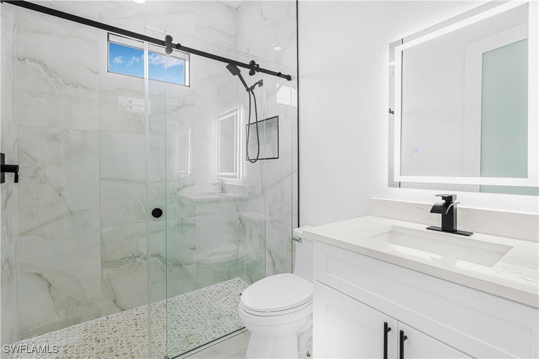 9007 East Crow Circle LaBelle, FL 33935 - Photo 32 of 46 a bathroom with a sink toilet and shower