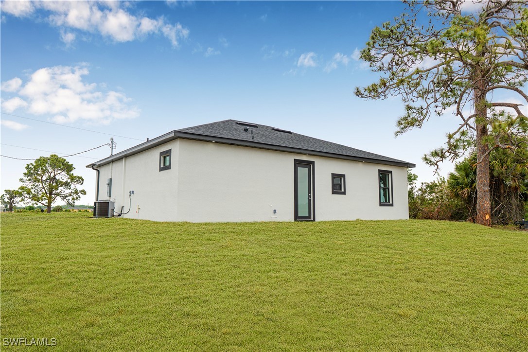 9007 East Crow Circle LaBelle, FL 33935 - Photo 37 of 46 a house with garden in front of it