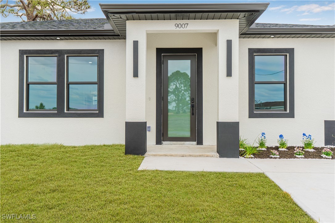 9007 East Crow Circle LaBelle, FL 33935 - Photo 9 of 46 a front view of a house with a yard