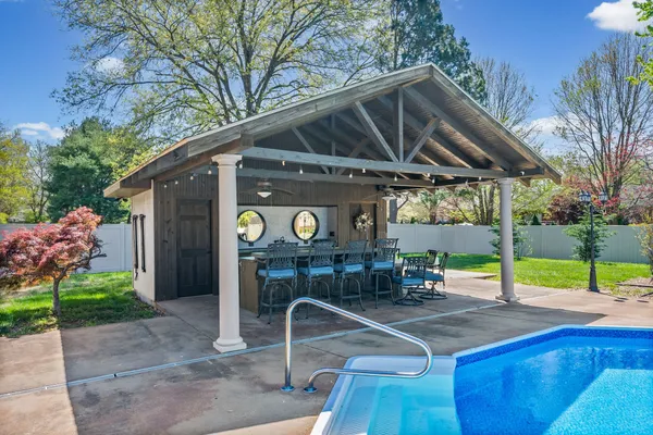 a view of a swimming pool with a yard