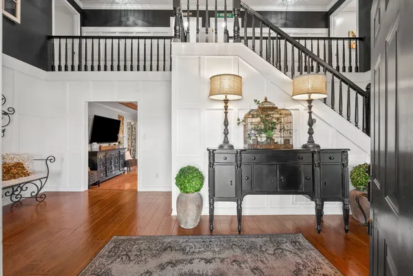a view of a hallway view with wooden floor and staircase