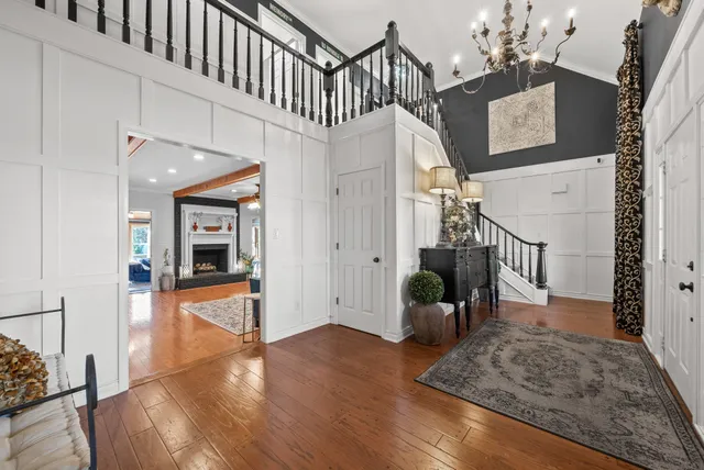 a view of entryway and hall with wooden floor
