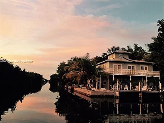 27316 Cayman Lane, Unit A Lower Keys, FL 33042 - Photo 11 of 47 a view of a large building with a big yard and large trees