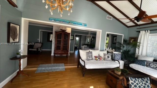 27316 Cayman Lane, Unit A Lower Keys, FL 33042 - Photo 12 of 47 a living room with furniture a flat screen tv and a floor to ceiling window