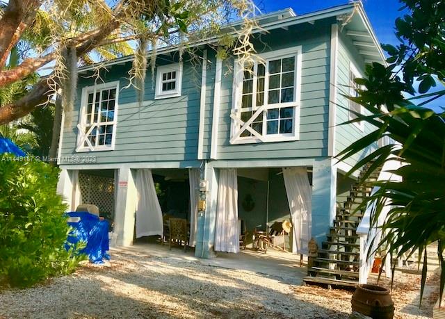 27316 Cayman Lane, Unit A Lower Keys, FL 33042 - Photo 3 of 47 a front view of a house with a tree