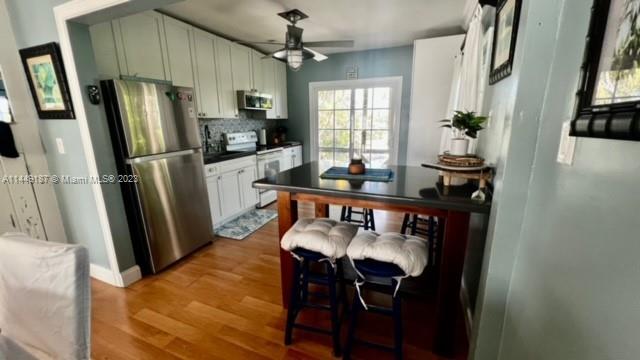 27316 Cayman Lane, Unit A Lower Keys, FL 33042 - Photo 31 of 47 a kitchen with stainless steel appliances a refrigerator a stove a sink dishwasher and microwave