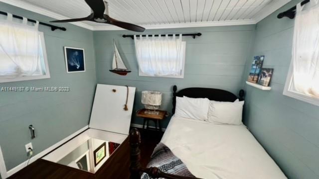 27316 Cayman Lane, Unit A Lower Keys, FL 33042 - Photo 32 of 47 a bedroom with a bed and a window