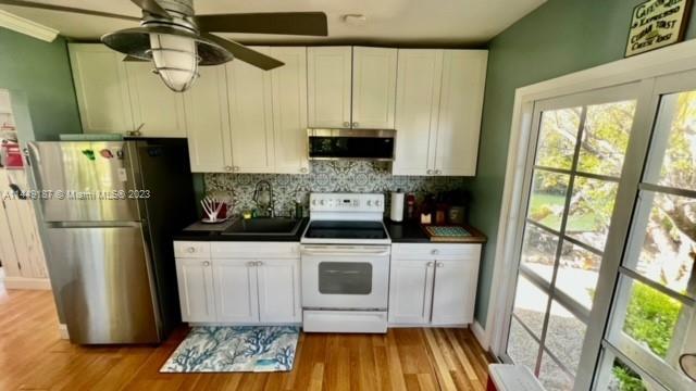 27316 Cayman Lane, Unit A Lower Keys, FL 33042 - Photo 39 of 47 a kitchen with stainless steel appliances granite countertop a refrigerator a stove and a sink with wooden floor