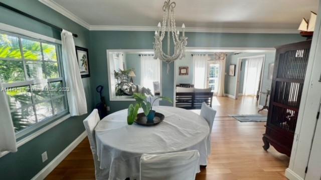 27316 Cayman Lane, Unit A Lower Keys, FL 33042 - Photo 4 of 47 a dining room with furniture a chandelier and wooden floor