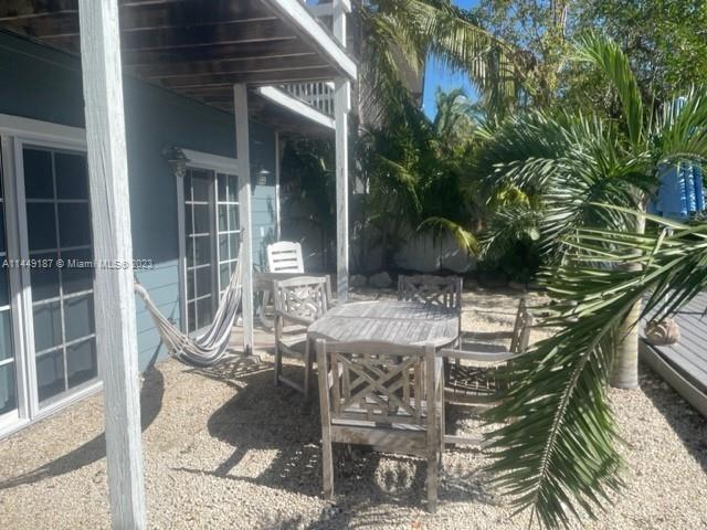 27316 Cayman Lane, Unit A Lower Keys, FL 33042 - Photo 44 of 47 a patio with table and chairs and potted plants