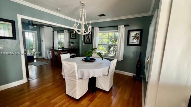 27316 Cayman Lane, Unit A Lower Keys, FL 33042 - Photo 5 of 47 a dining room with furniture a chandelier and wooden floor