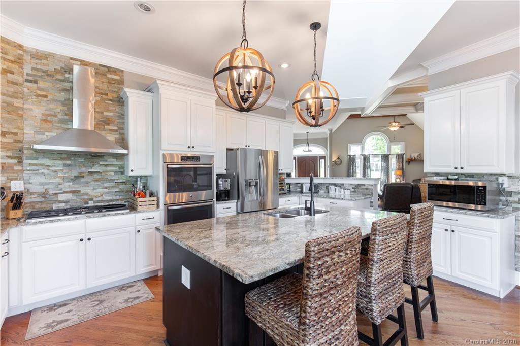231 Pennington Road Rock Hill, SC 29732 - Photo 15 of 46 a kitchen with center island and chandelier