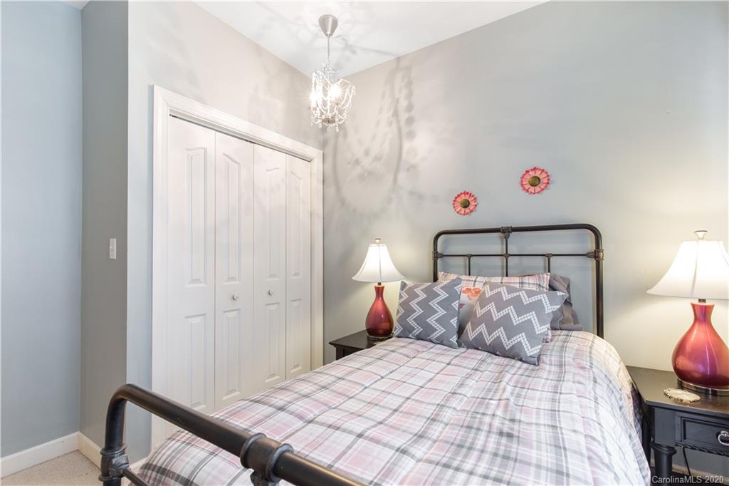 231 Pennington Road Rock Hill, SC 29732 - Photo 23 of 46 a bedroom with a bed and a lamp on dresser