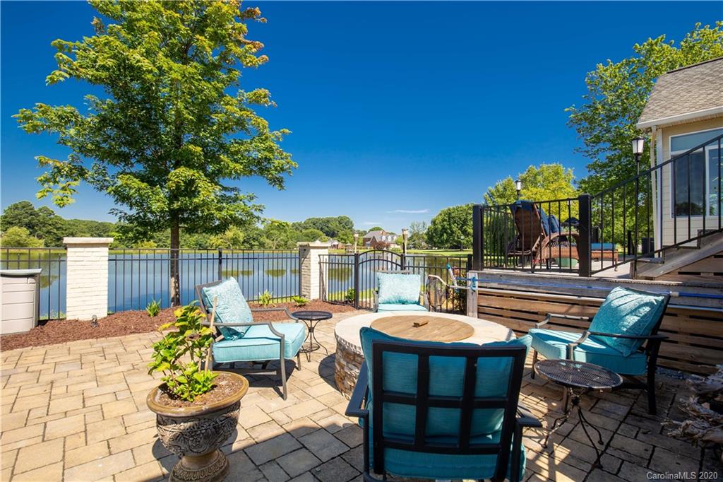 231 Pennington Road Rock Hill, SC 29732 - Photo 37 of 46 a view of a patio with couches table and chairs under an umbrella with potted plants
