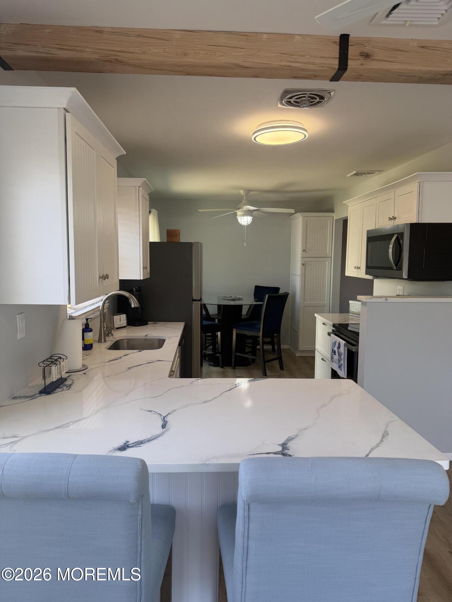 31 Homestead Drive, Unit A Whiting, NJ 08759 - Photo 13 of 23 a large kitchen with a large counter top appliances and cabinets