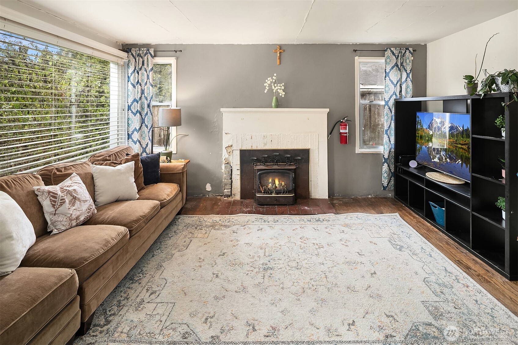 3404 Southeast 5th Street Renton, WA 98058 - Photo 4 of 24 a living room with furniture a flat screen tv and a fireplace