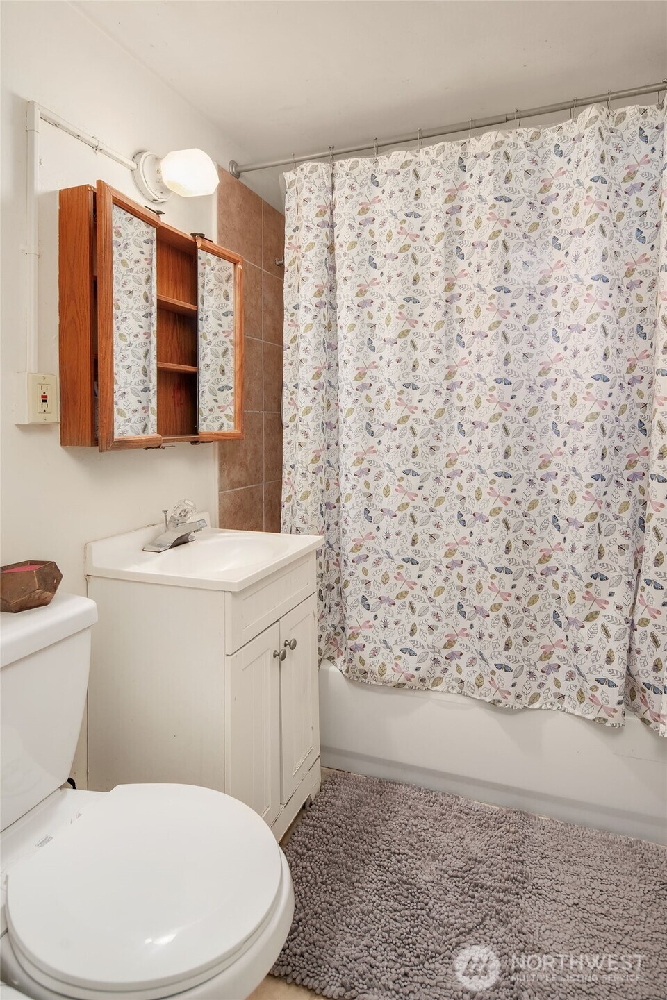 3404 Southeast 5th Street Renton, WA 98058 - Photo 9 of 24 a bathroom with a toilet a sink and a mirror