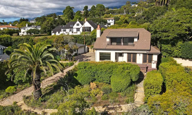 a front view of a house with a garden