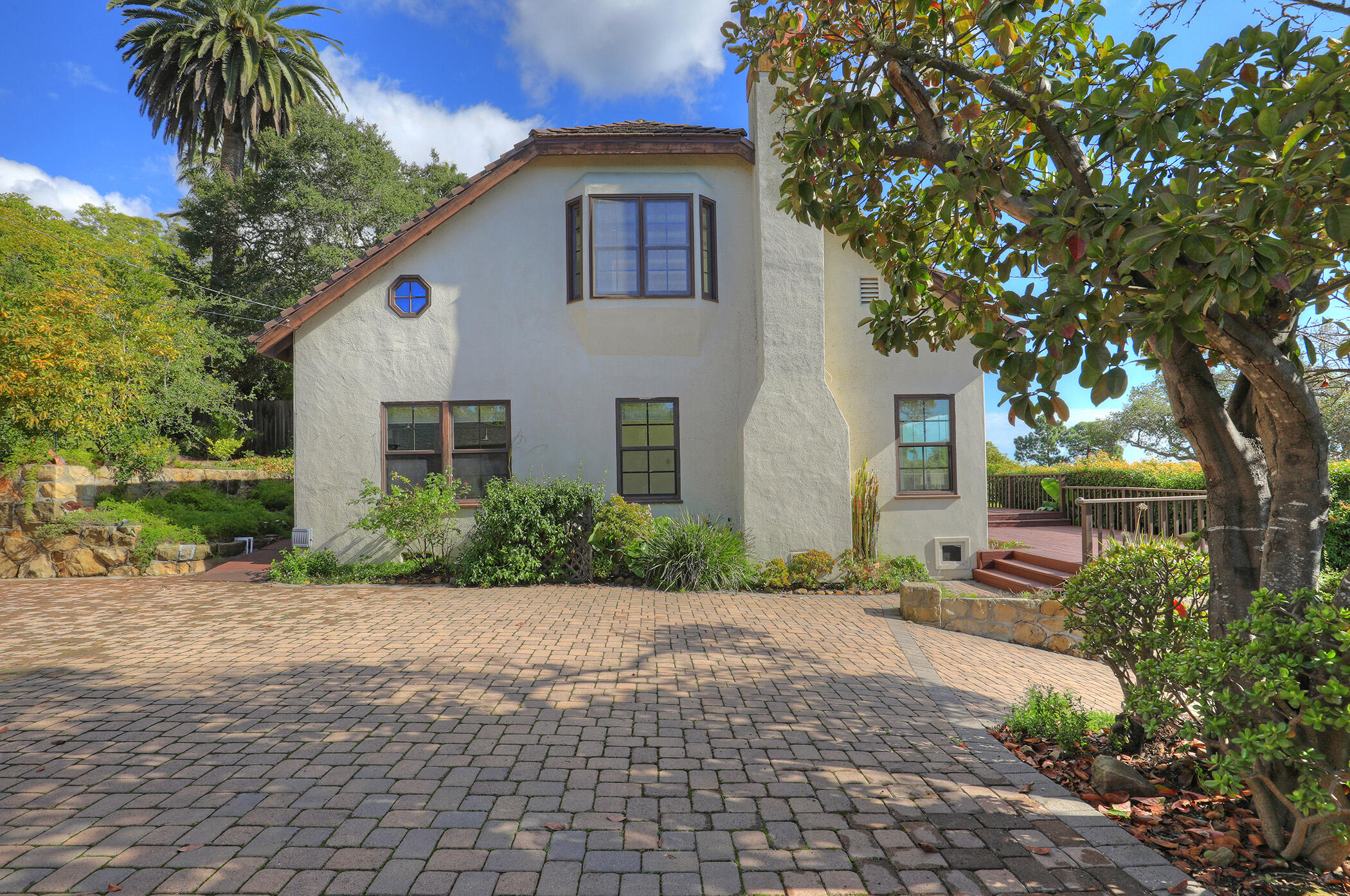 1712 Lasuen Road Santa Barbara, CA 93103 - Photo 29 of 38 a front view of a house with a yard and potted plants