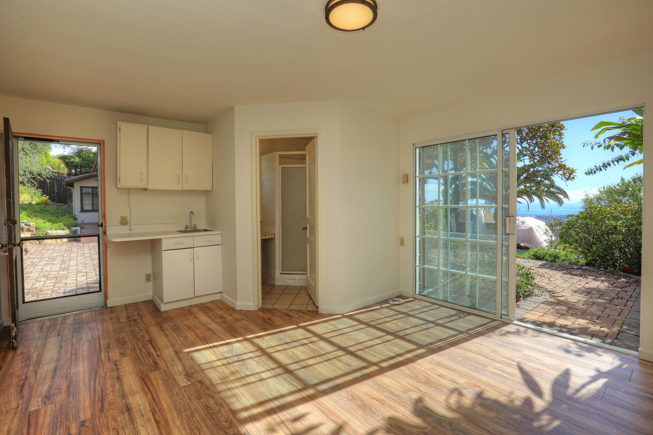 1712 Lasuen Road Santa Barbara, CA 93103 - Photo 31 of 38 a bedroom with a bed and a cabinets