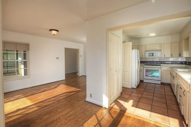 a kitchen with stainless steel appliances a refrigerator and a stove top oven