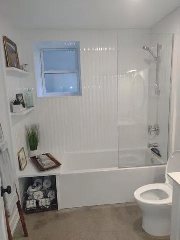 a bathroom with a sink a toilet and bathtub